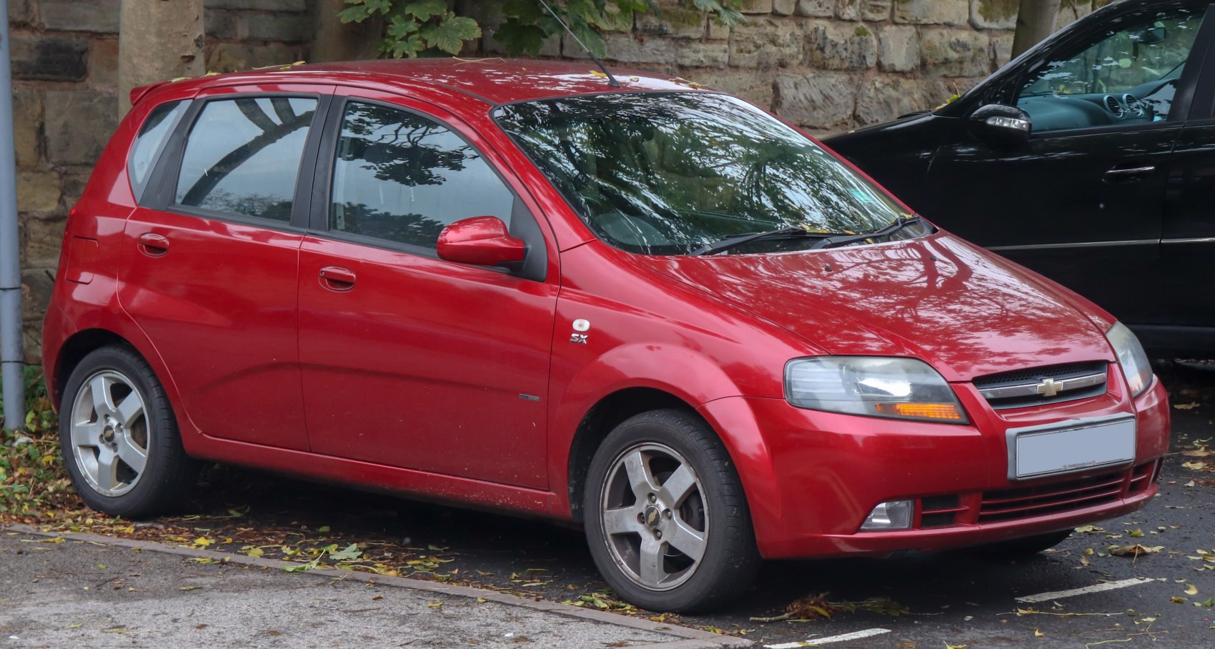 Compact 5-door hatchback with alloy wheels and rear roof spoiler