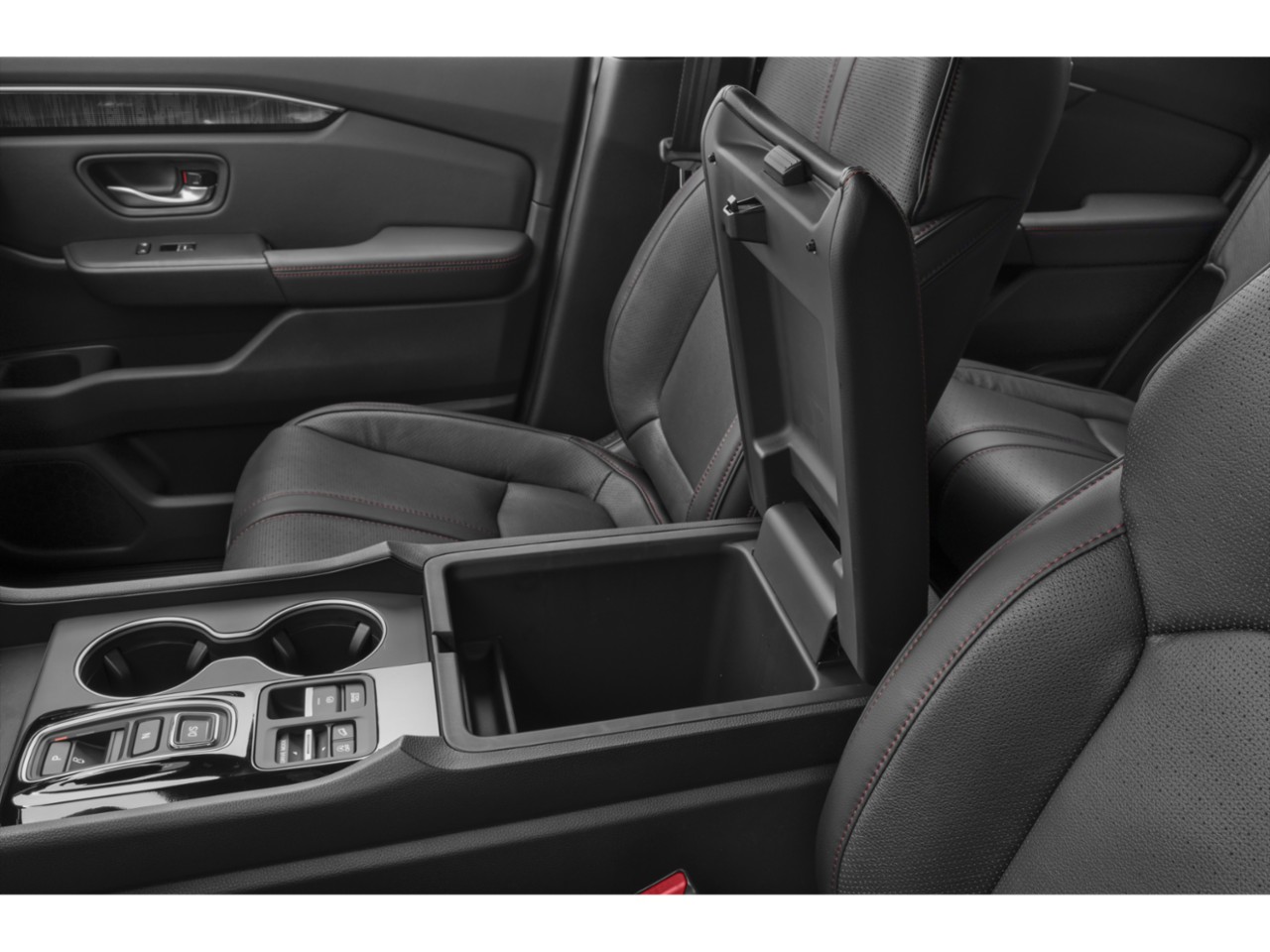 Open center console with leather seats and red stitching