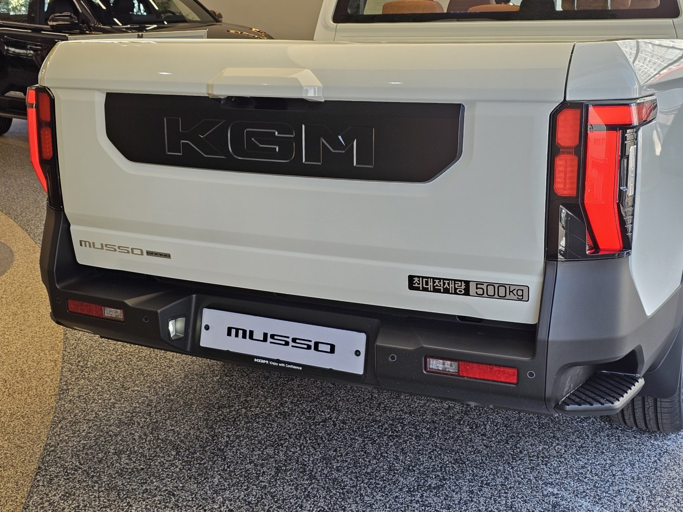 Pickup truck rear featuring bold branding and modern taillights