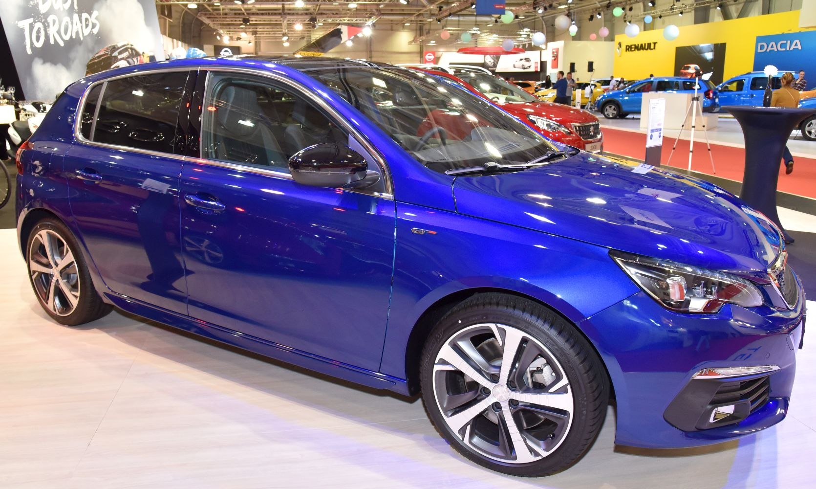 Blue hatchback side view with alloy wheels and sleek design
