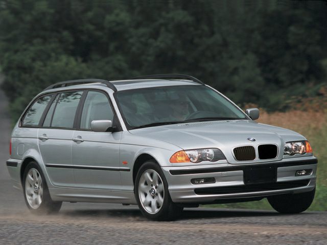 Silver estate car front and side view on gravel road