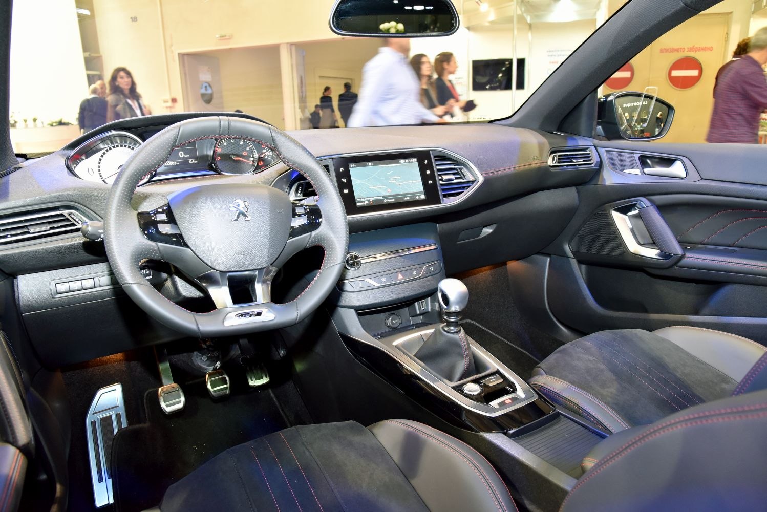 Modern car interior with sporty steering wheel and manual gear shift