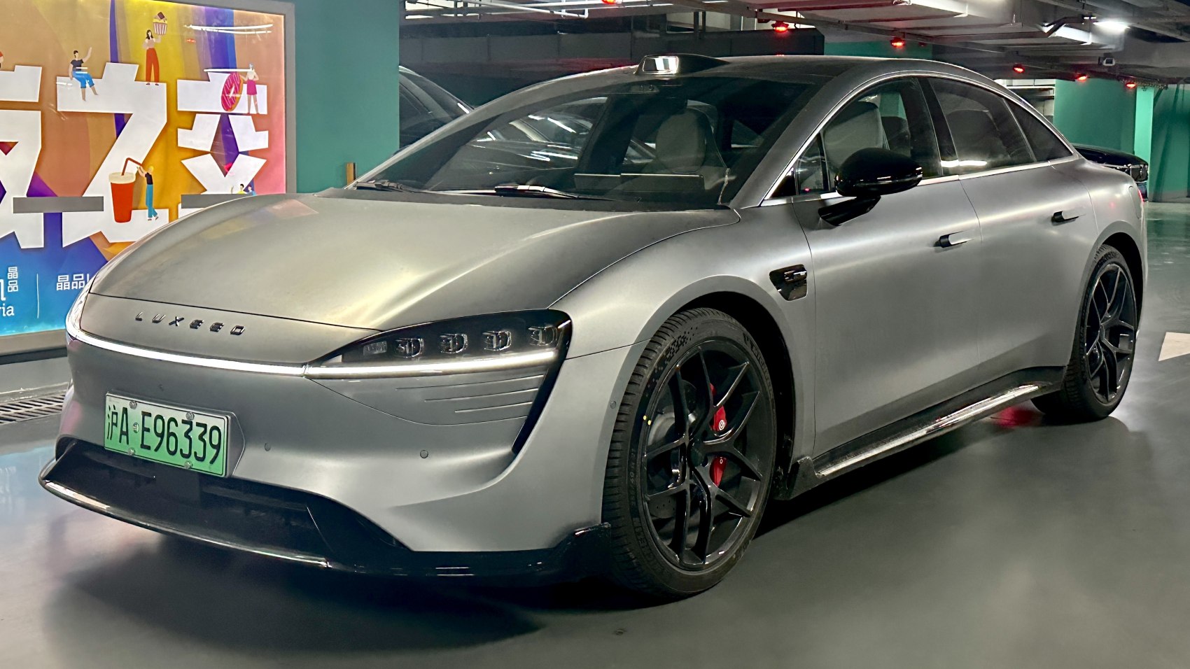 Front and side view with LED headlights and sporty black rims with red calipers.