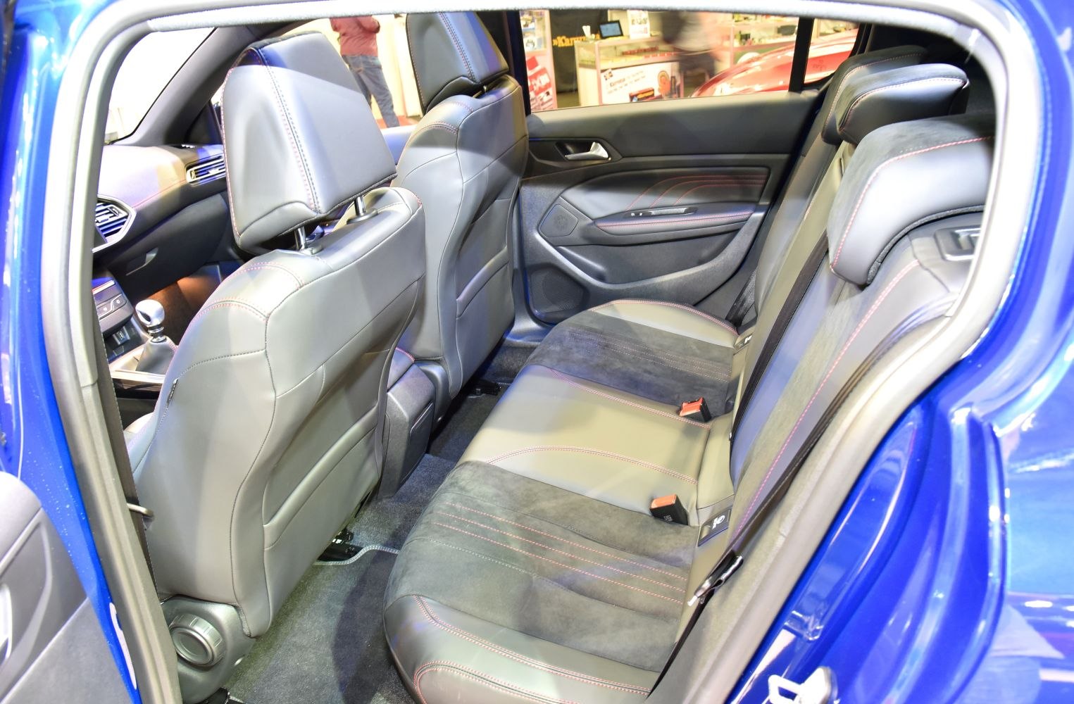 Rear leather seats with red stitching and spacious interior