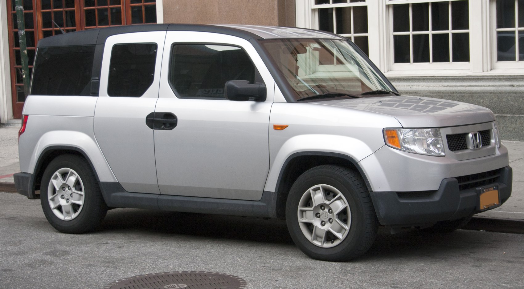 Boxy, rugged SUV with distinctive angular design and unique rear side doors