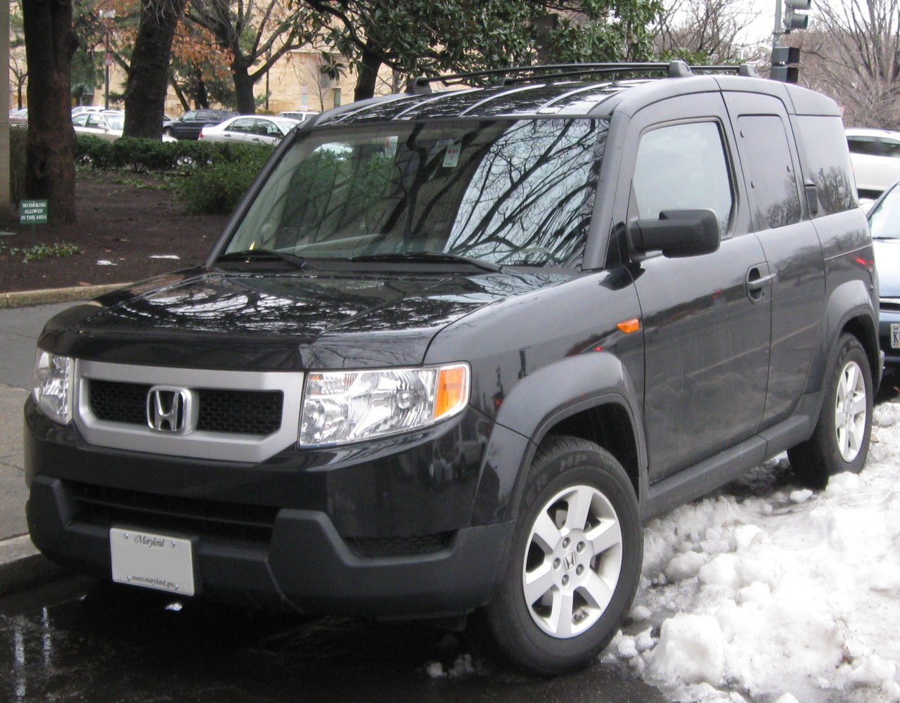 Boxy SUV with roof rails and alloy wheels in black color
