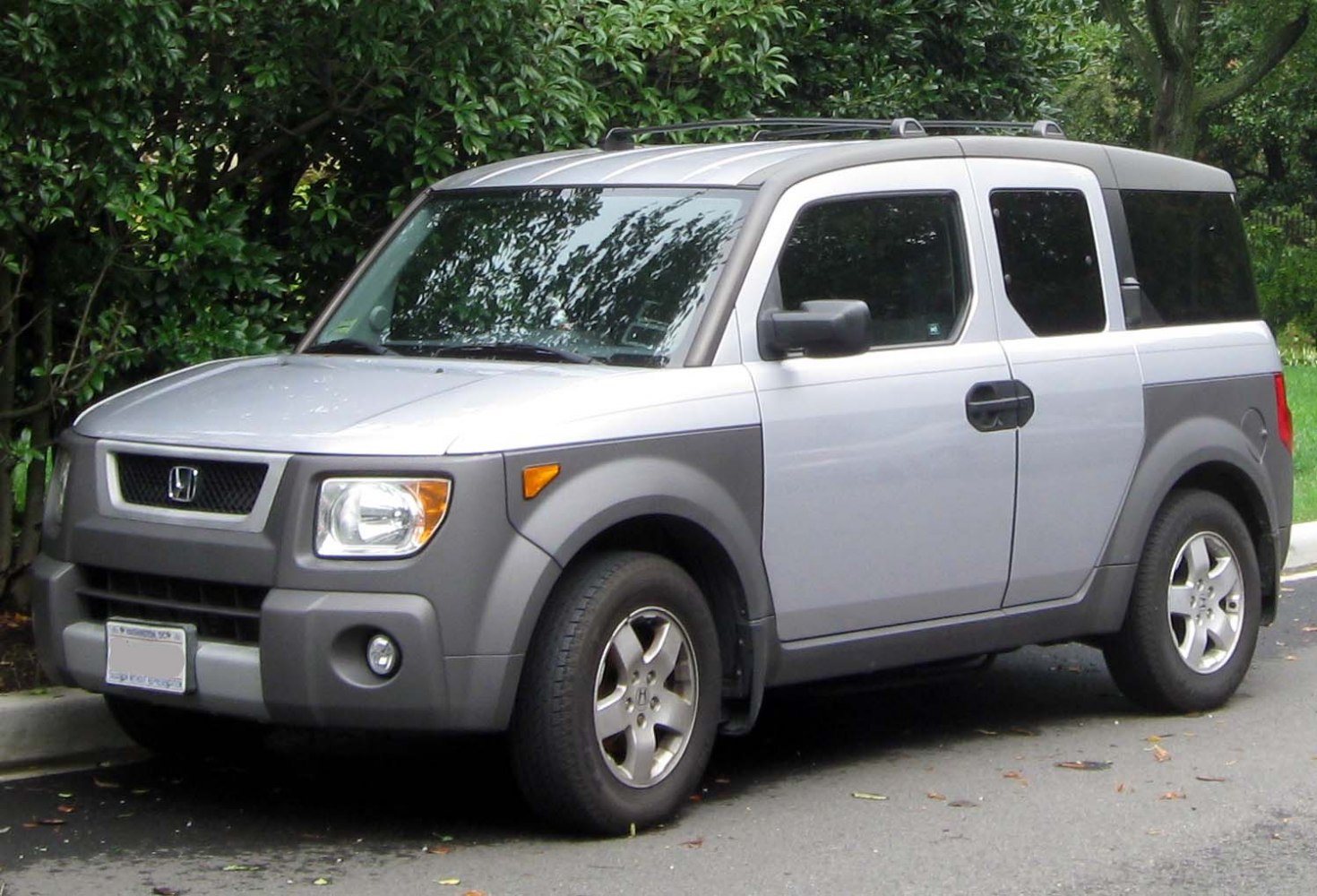 Boxy SUV front side view with roof rails and alloy wheels