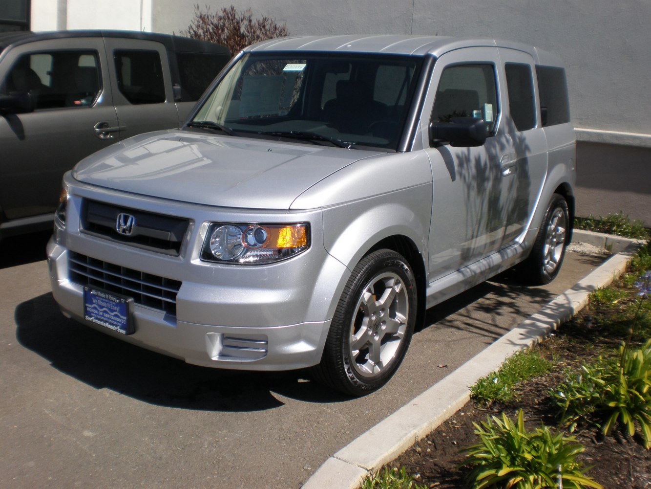 Silver SUV with boxy design and clear headlight details