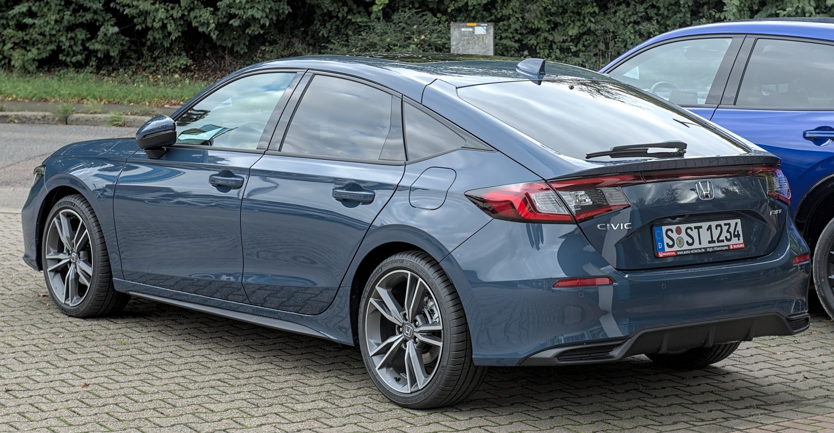 Rear and side view with sharp tail lights and alloy wheels