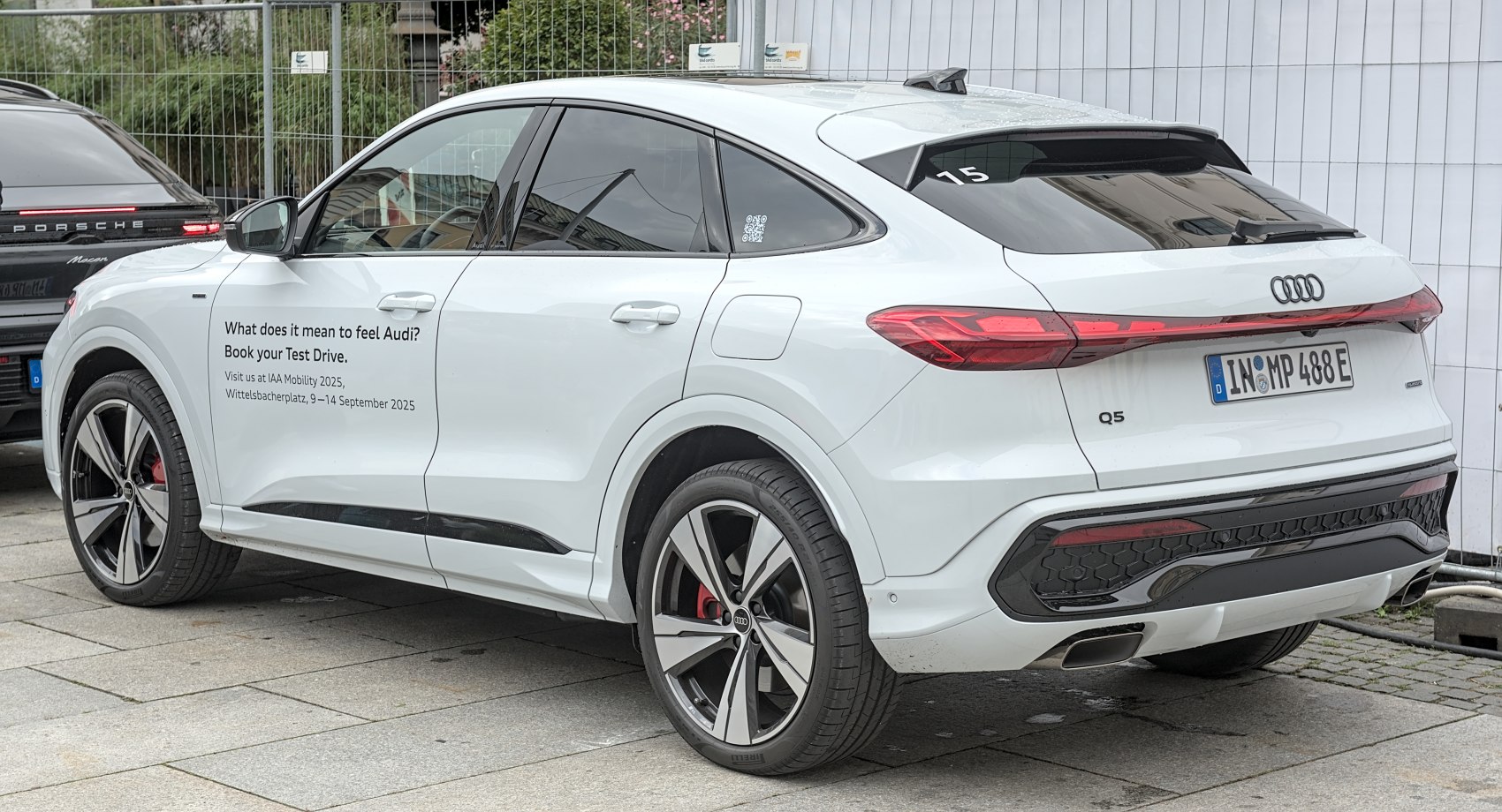 Rear and side view of coupe-style SUV with sloping roofline and distinctive alloy wheels.
