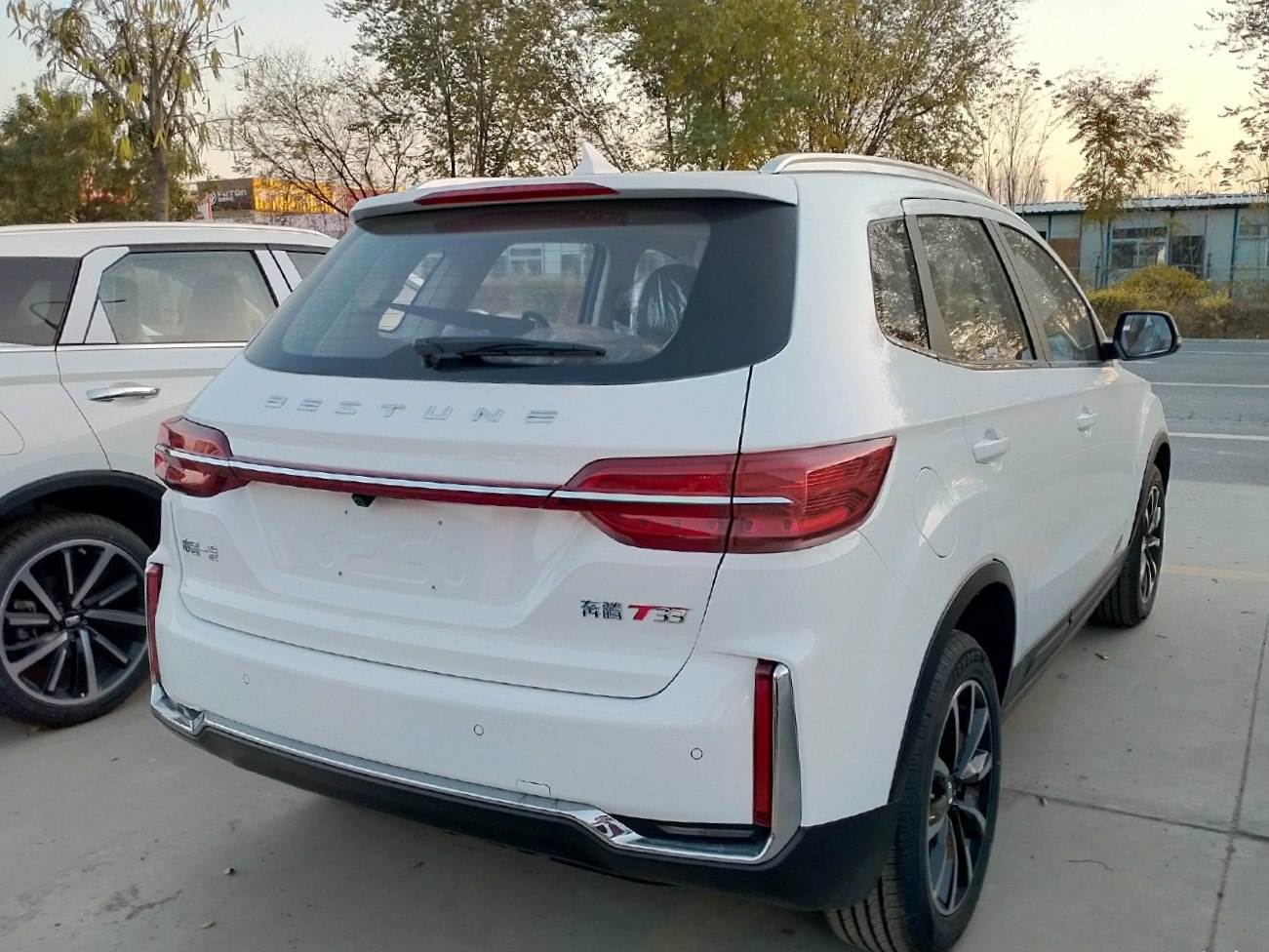 Rear view of SUV with sleek horizontal taillights and integrated spoiler