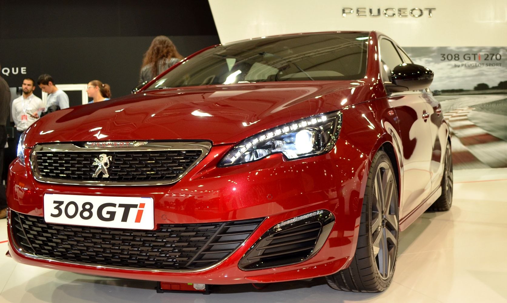 Close-up of red car front with grille and LED headlights