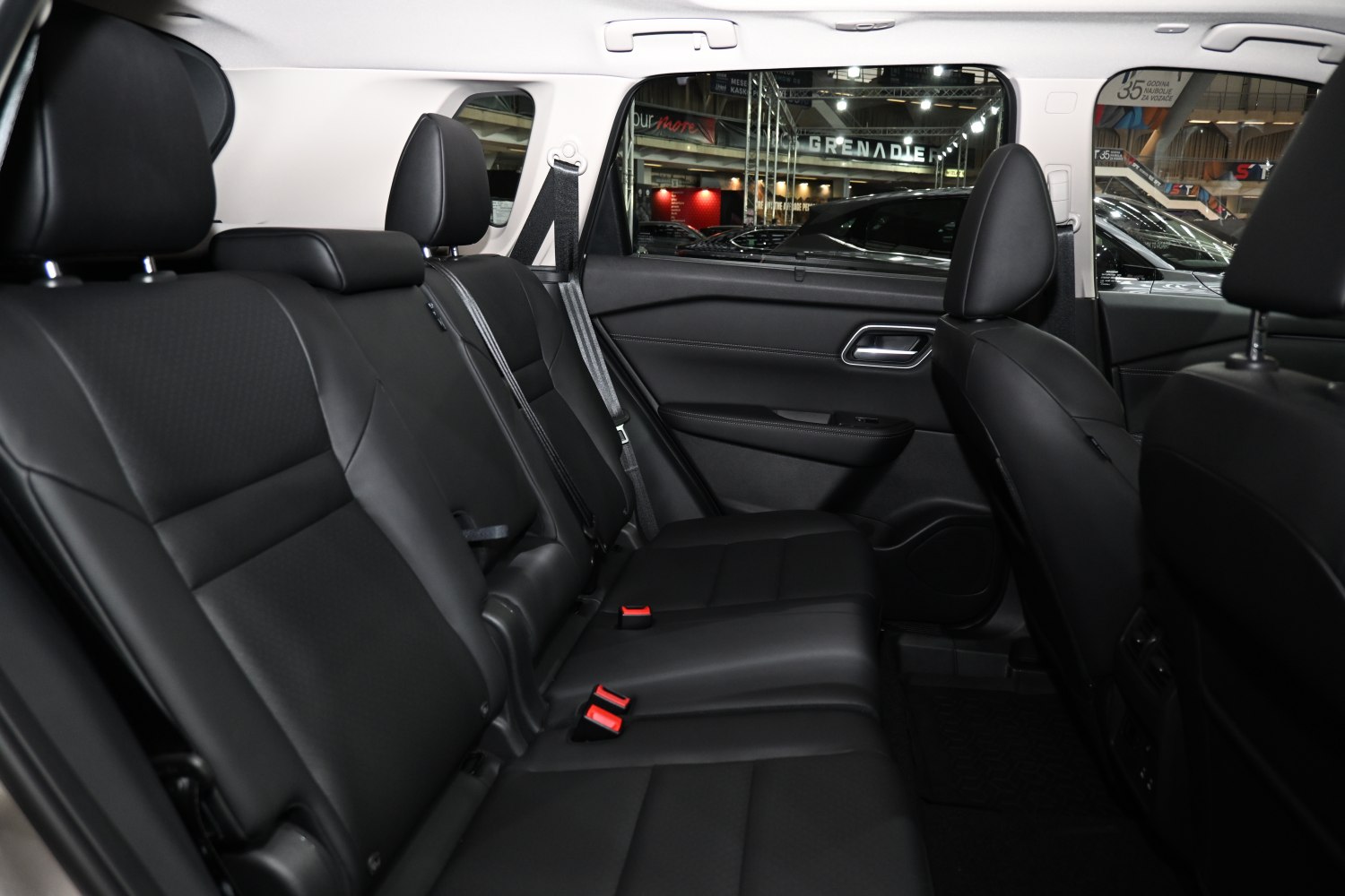 Black leather rear seats with headrests and seatbelts