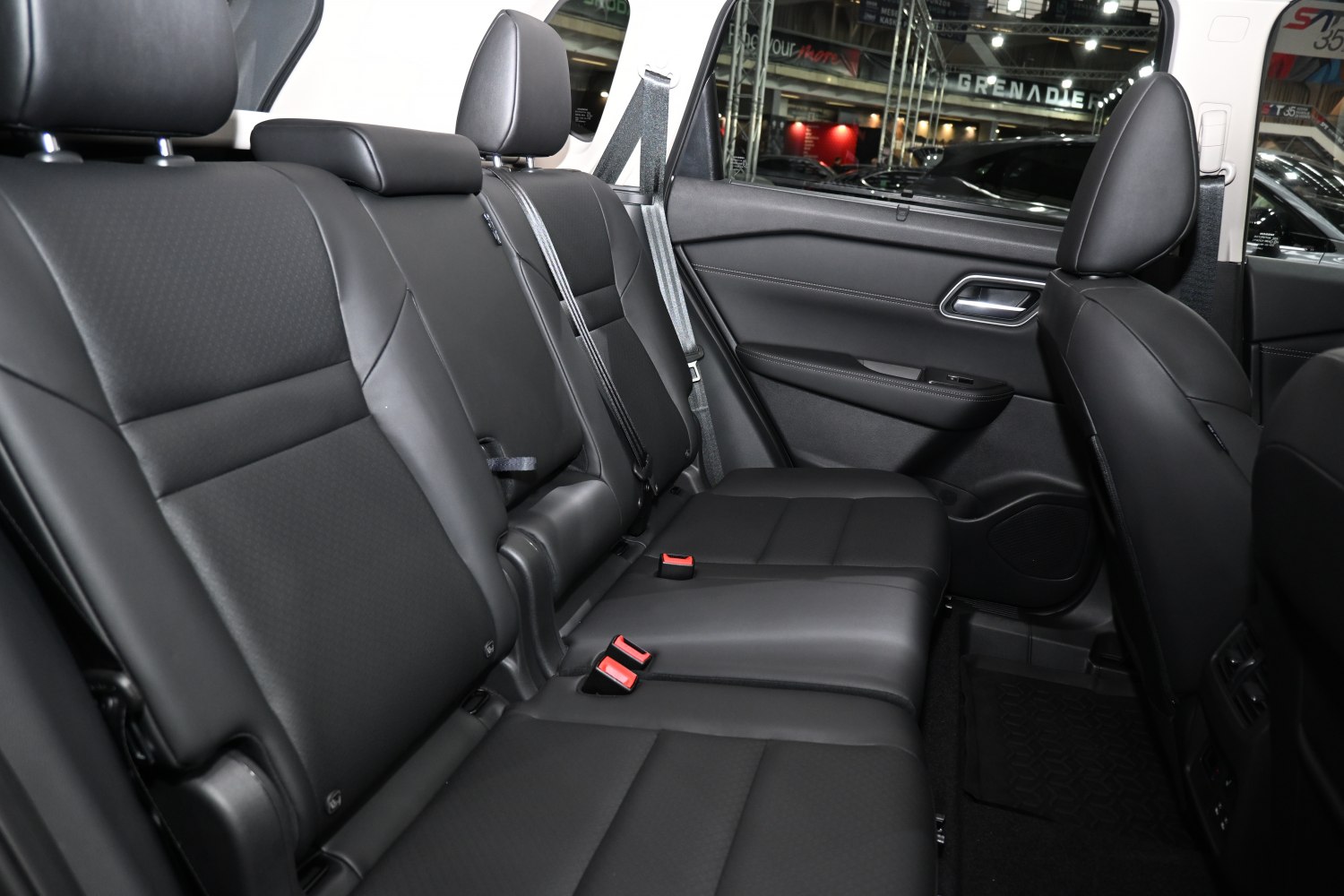 Spacious black leather rear seats with headrests and seatbelts