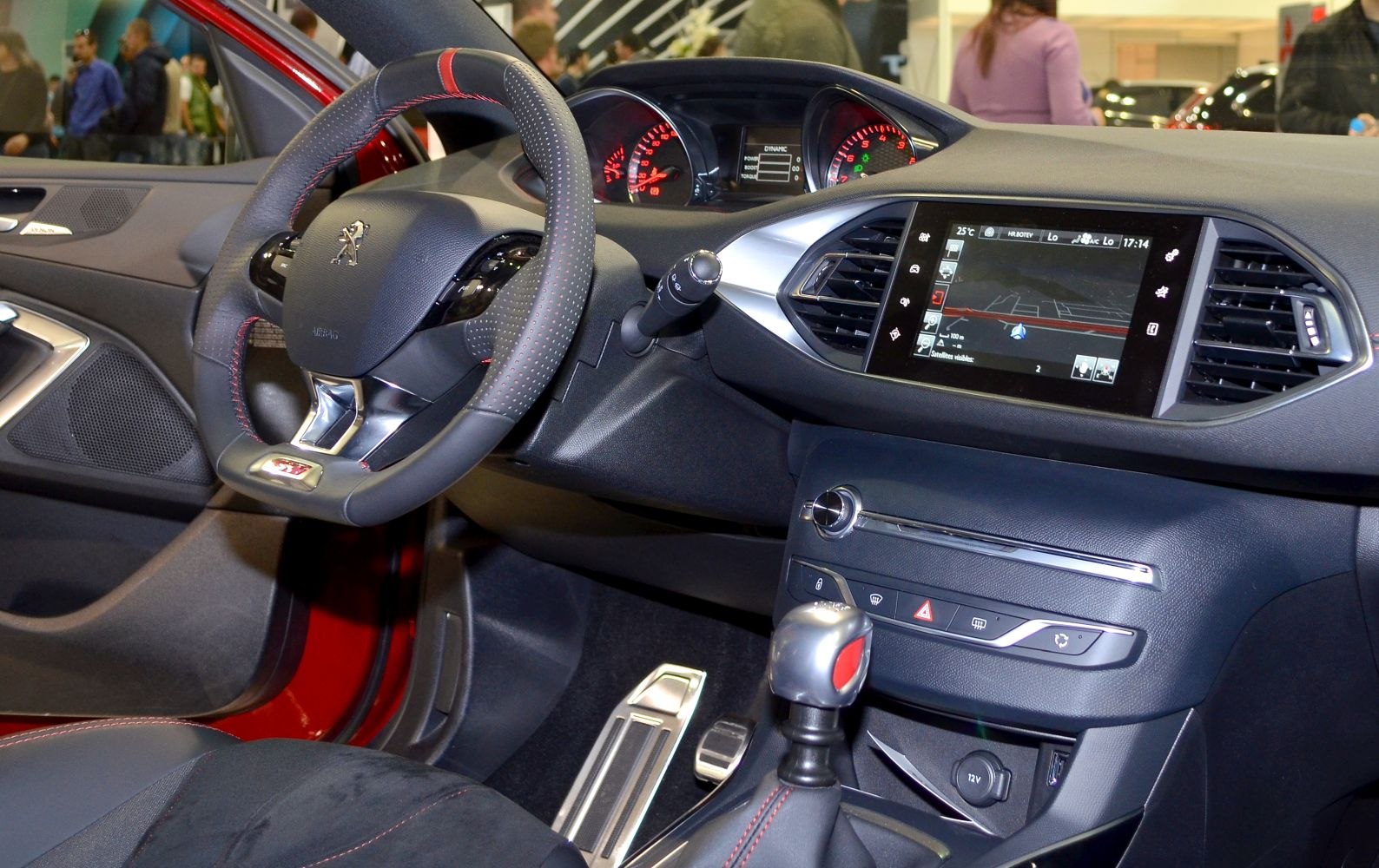 Sporty steering wheel and touchscreen dashboard display.