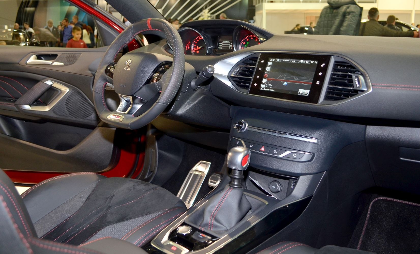 Touchscreen navigation and manual gear shift in a modern car interior