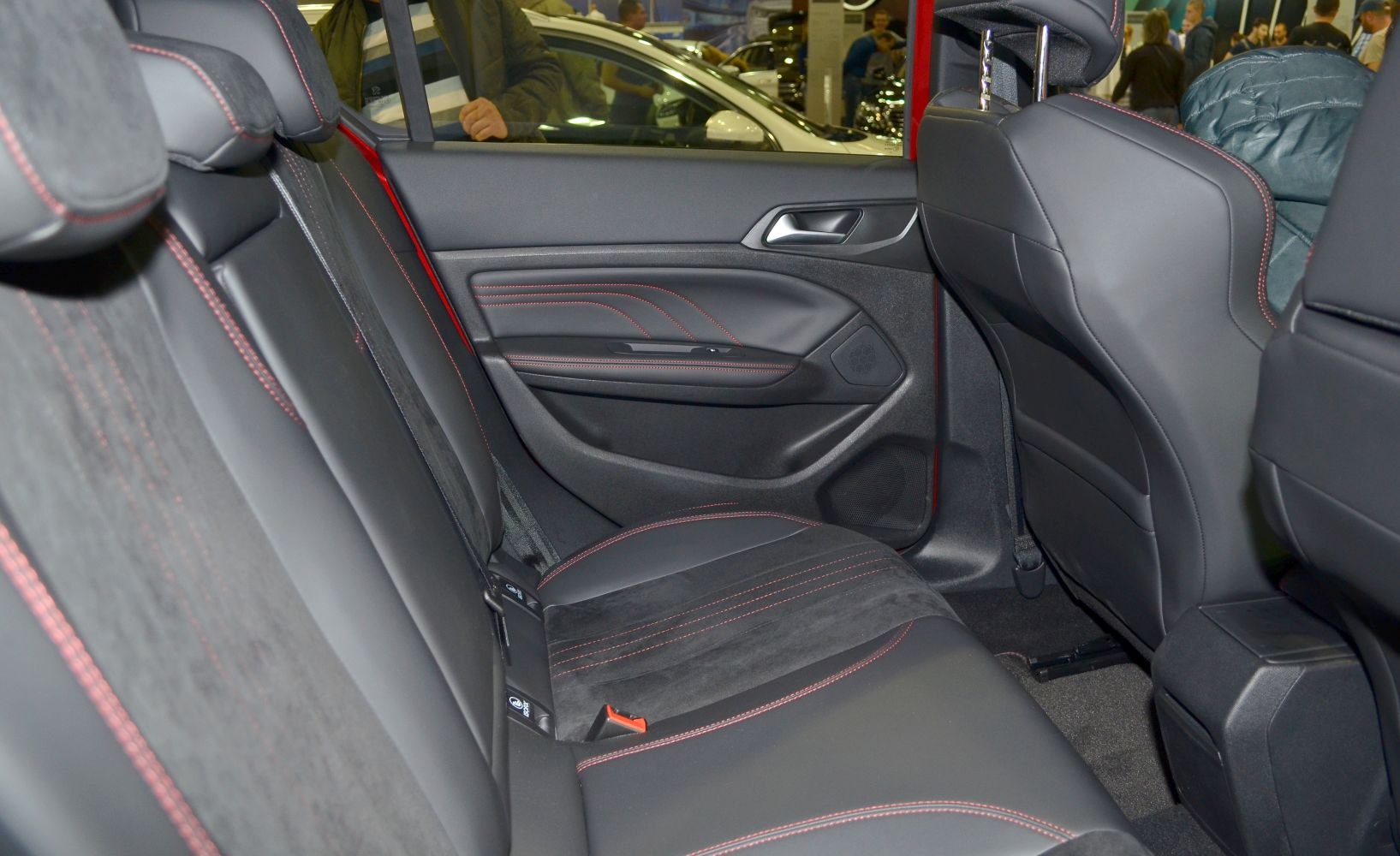 Rear seats with black leather upholstery and red stitching