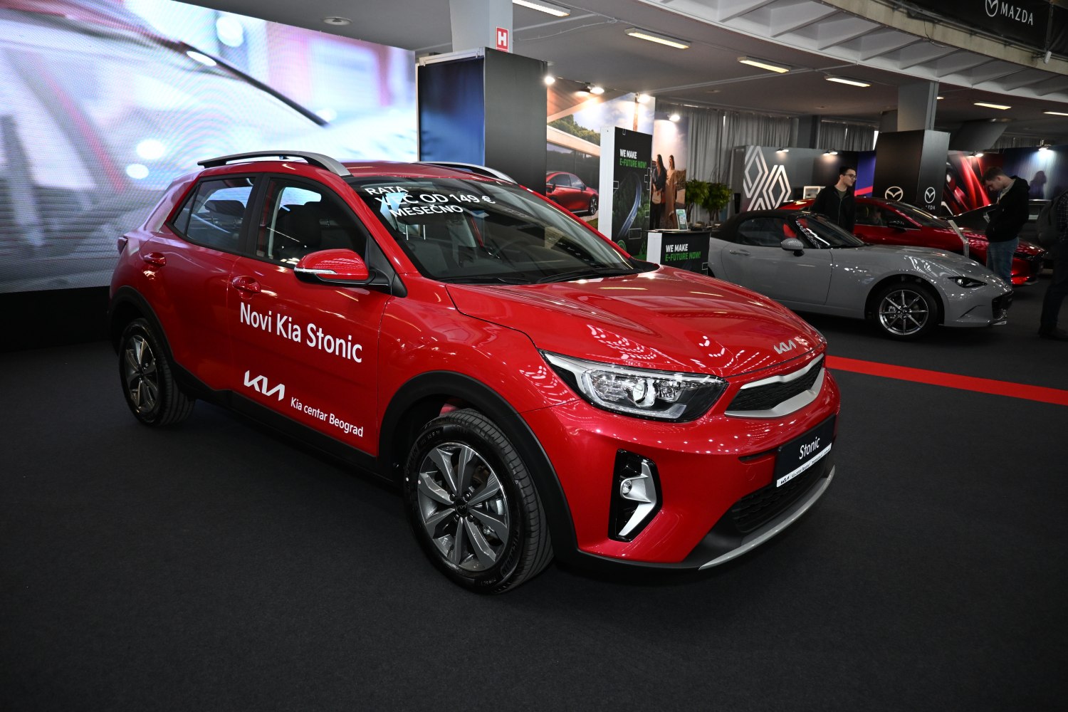 Red compact crossover with modern headlights and alloy wheels