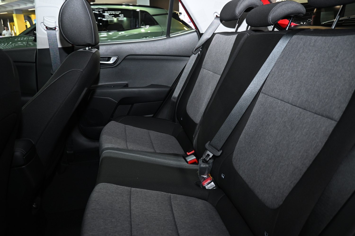 Rear seat with fabric upholstery and integrated seat belts