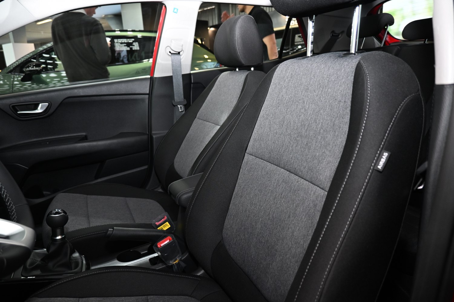 Two-tone fabric front seats with manual gear knob and seatbelt