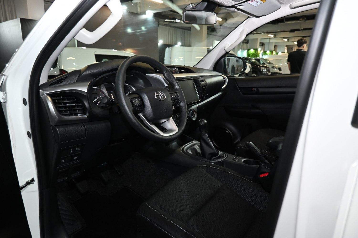 Modern dashboard and steering wheel with manual gear shift in pickup interior