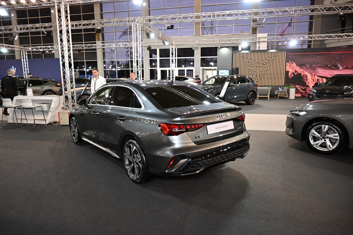 Rear and side view of sedan with sporty alloy wheels and sharp taillights