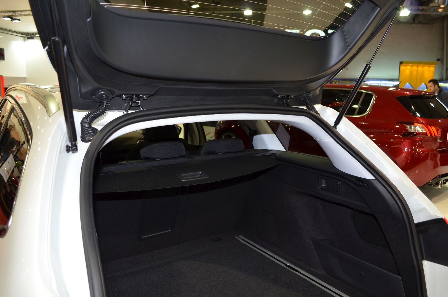 Open spacious rear trunk of an estate vehicle with cargo cover