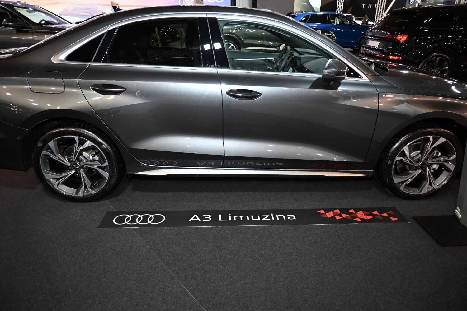 Side profile of a sleek sedan with distinctive alloy wheels