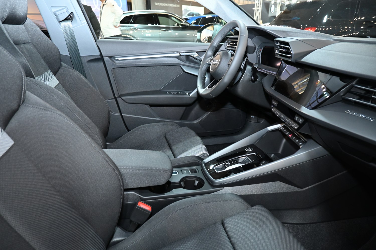 Modern car interior with digital dashboard and fabric seats