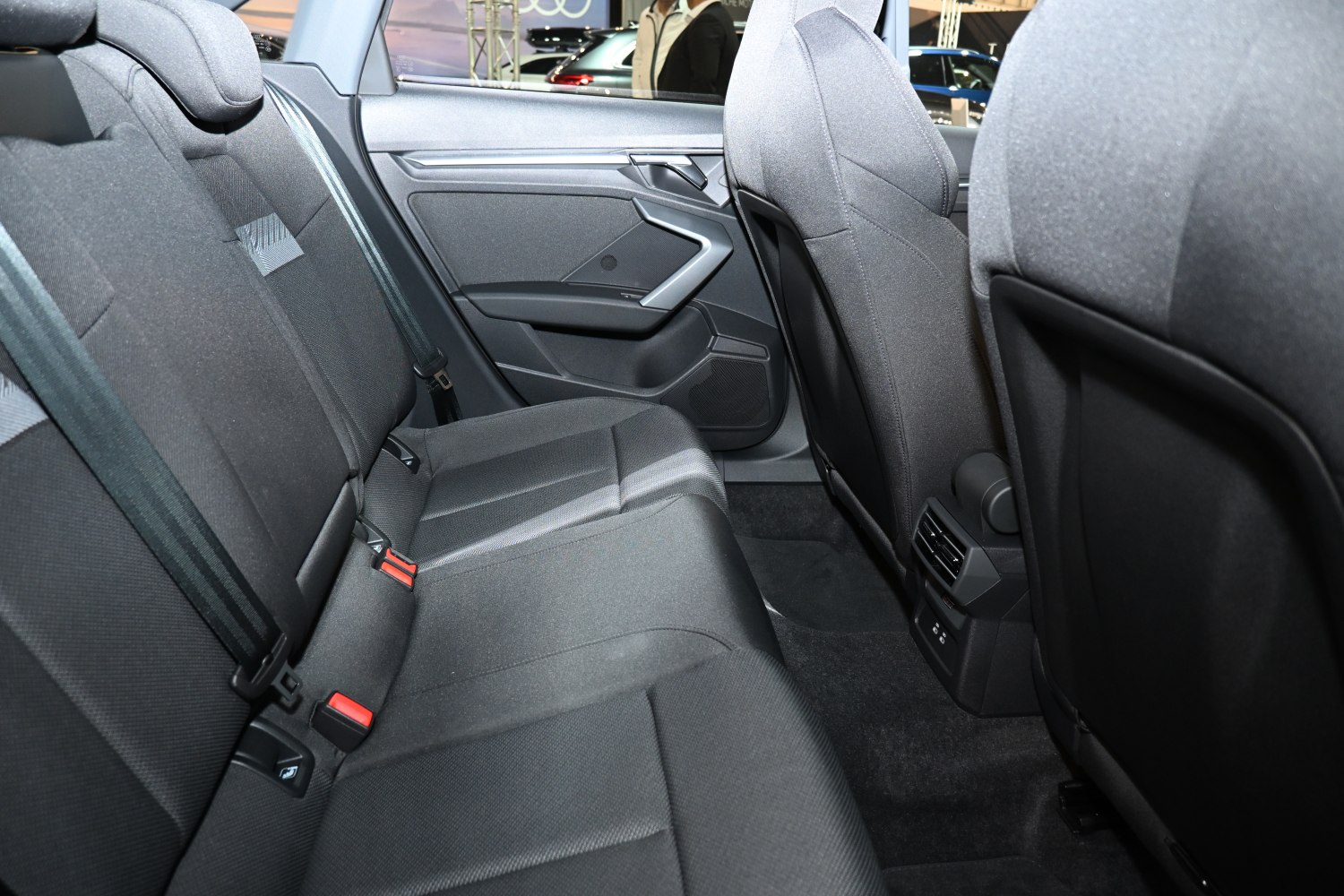 Rear passenger seat area with fabric upholstery and rear ventilation