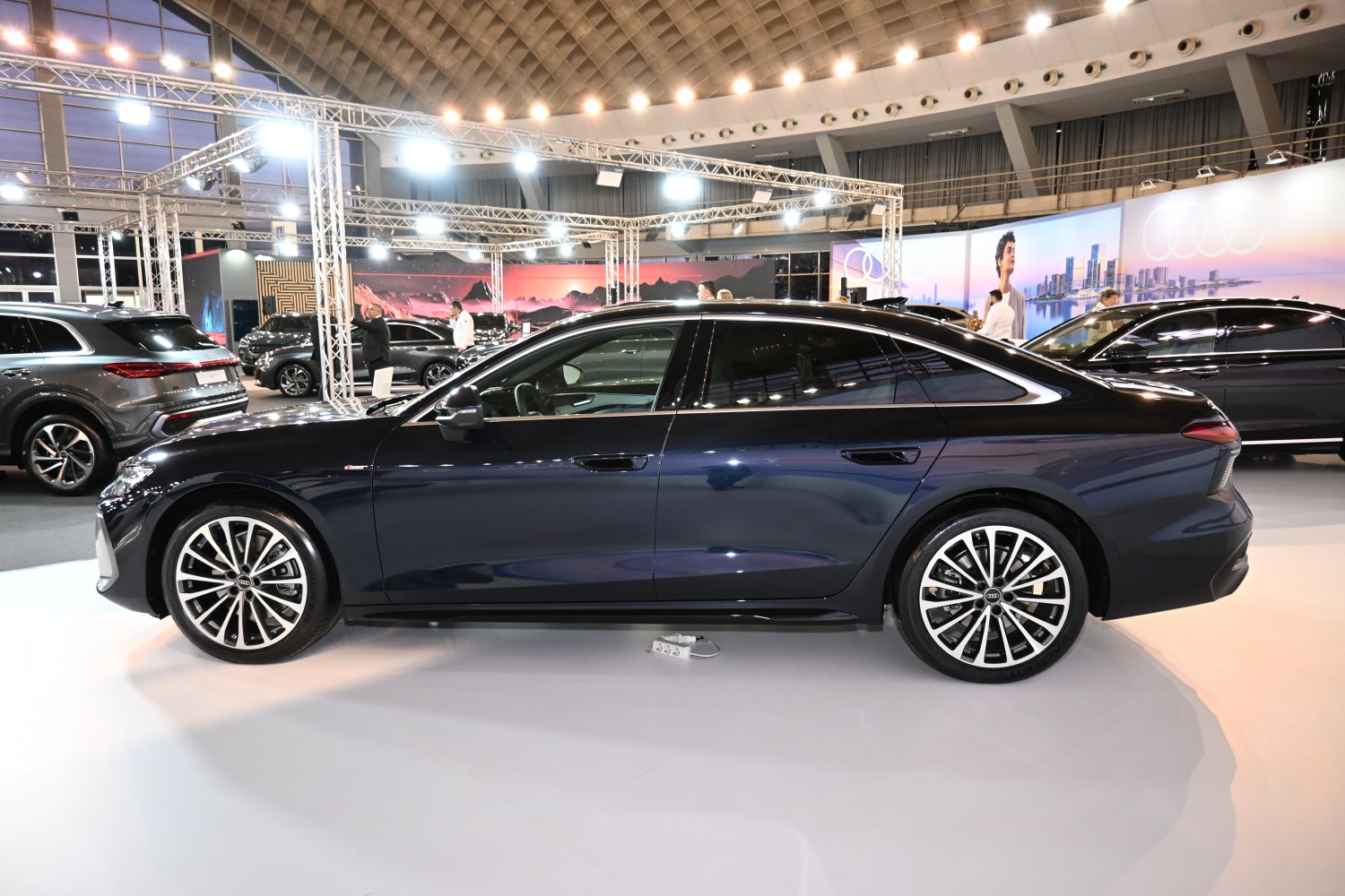 Side profile of a sleek sedan with detailed alloy wheels and smooth body lines.