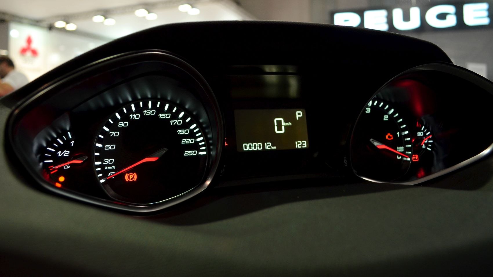 Close-up of dashboard speedometer, tachometer, fuel gauge, and digital display.