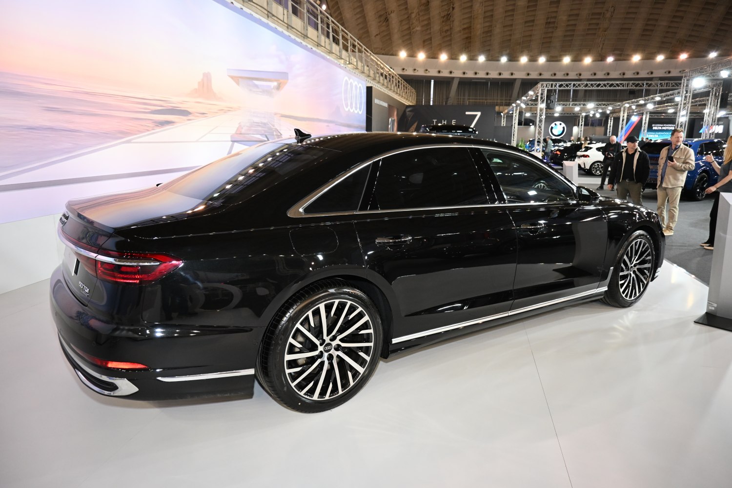 Rear side view of sleek black luxury sedan with alloy wheels