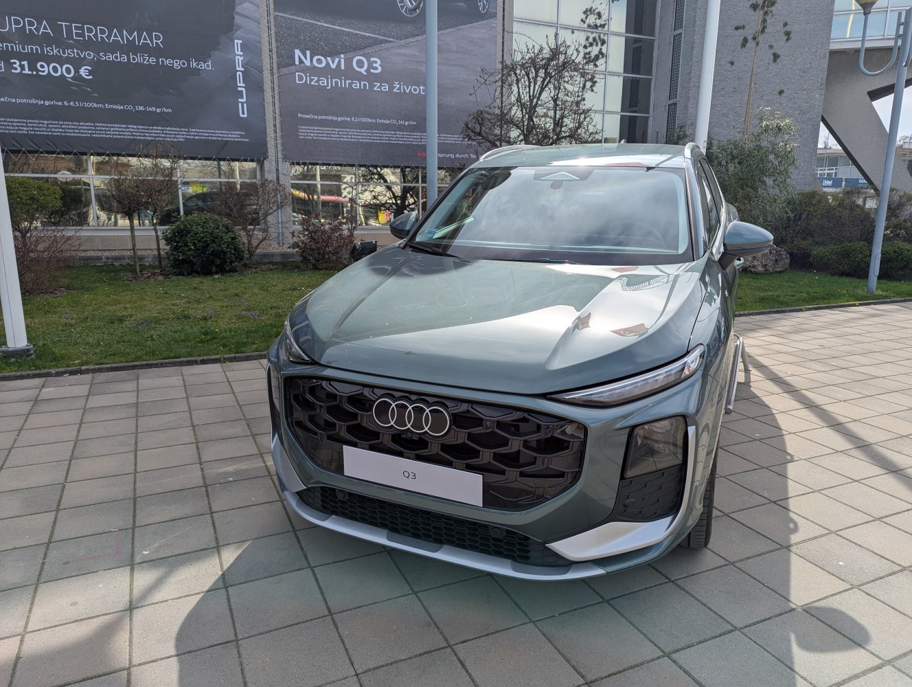 Front view of SUV with large hexagonal grille and slim headlights with vertical LEDs