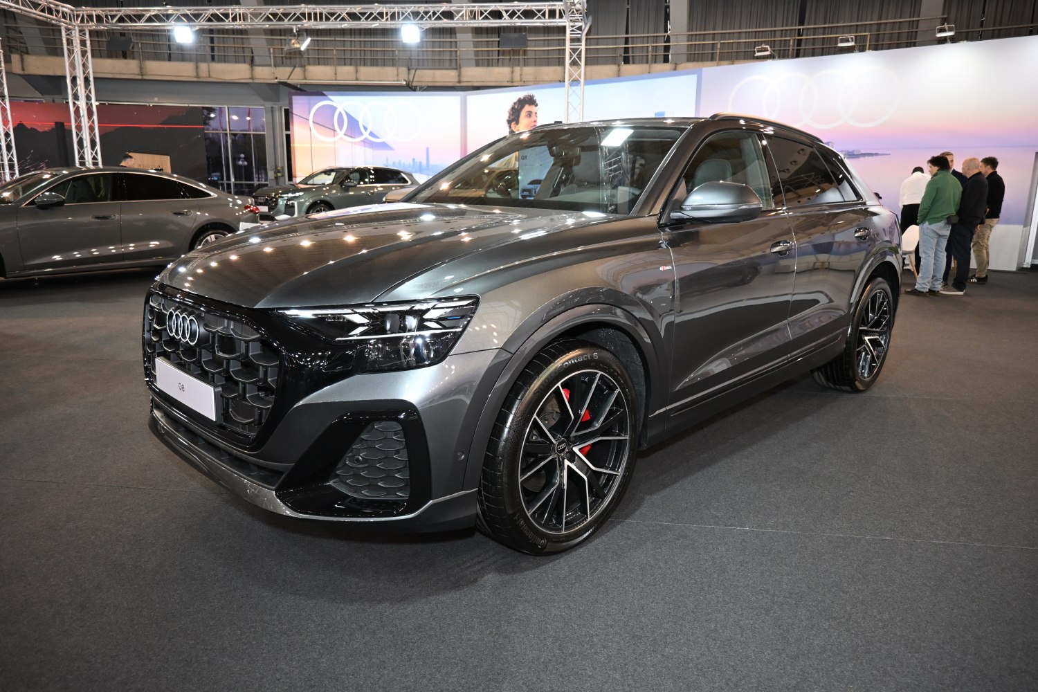 Front and side view of a luxury SUV with black honeycomb grille and alloy wheels