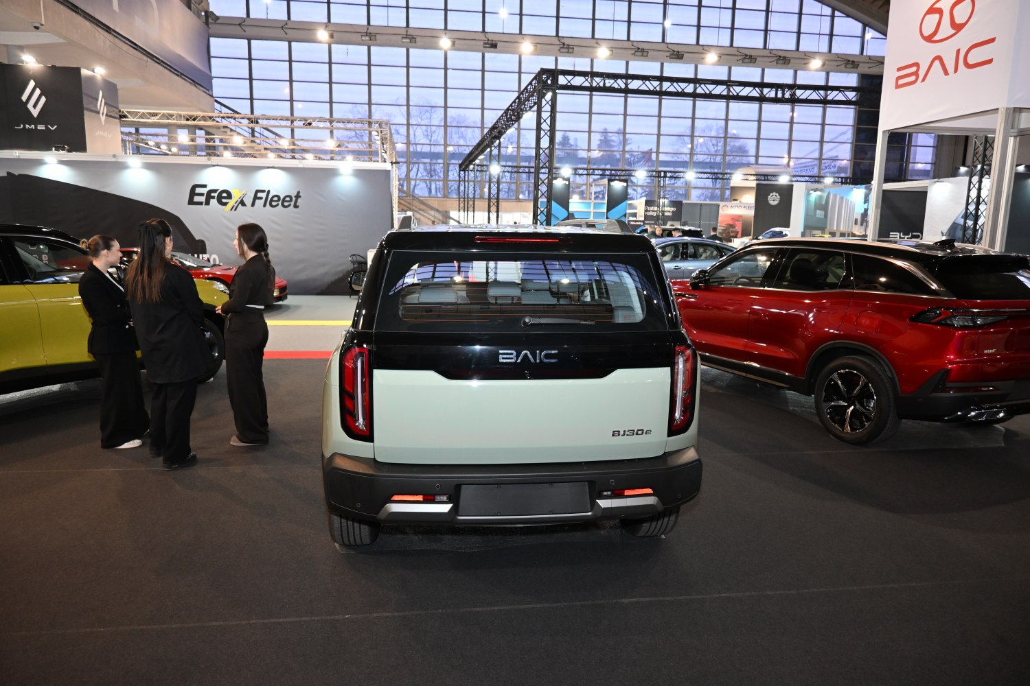 Rear view of vehicle with vertical tail lights and black panel