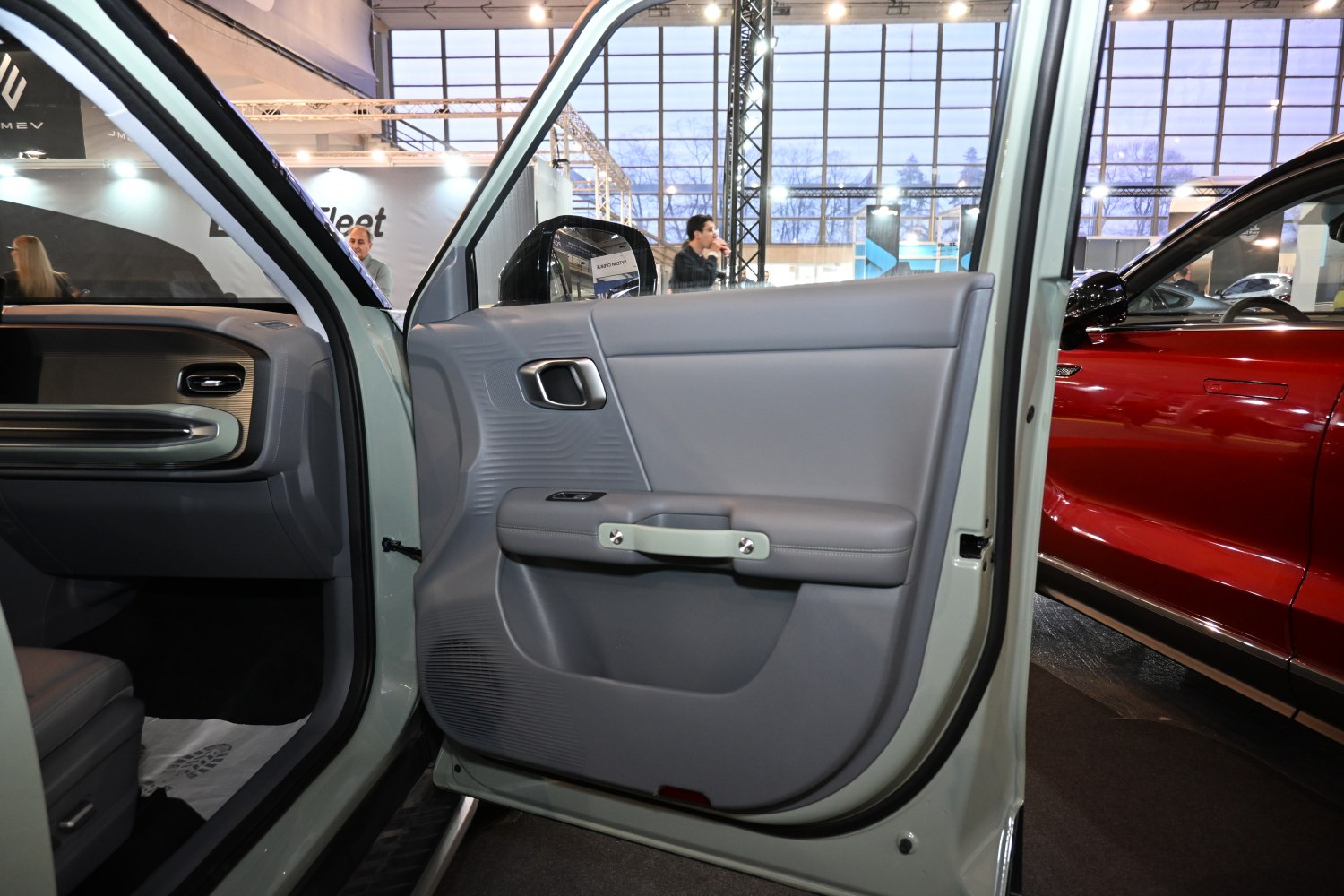 Interior door panel with ergonomic handle and textured design