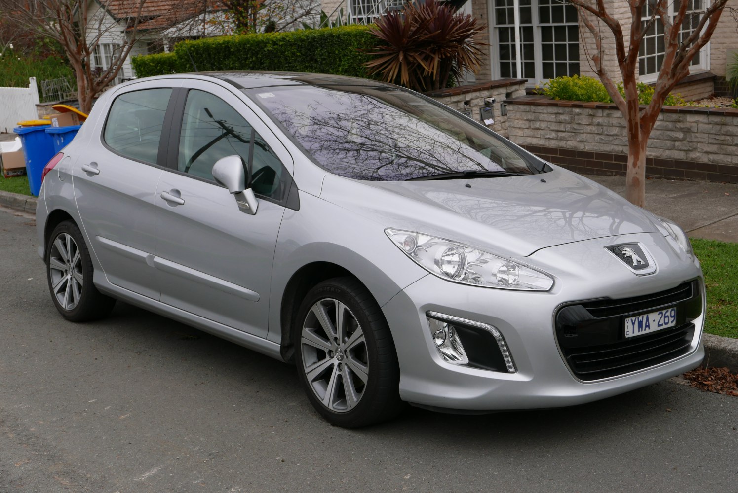 Silver five-door hatchback with LED daytime running lights and sleek headlights