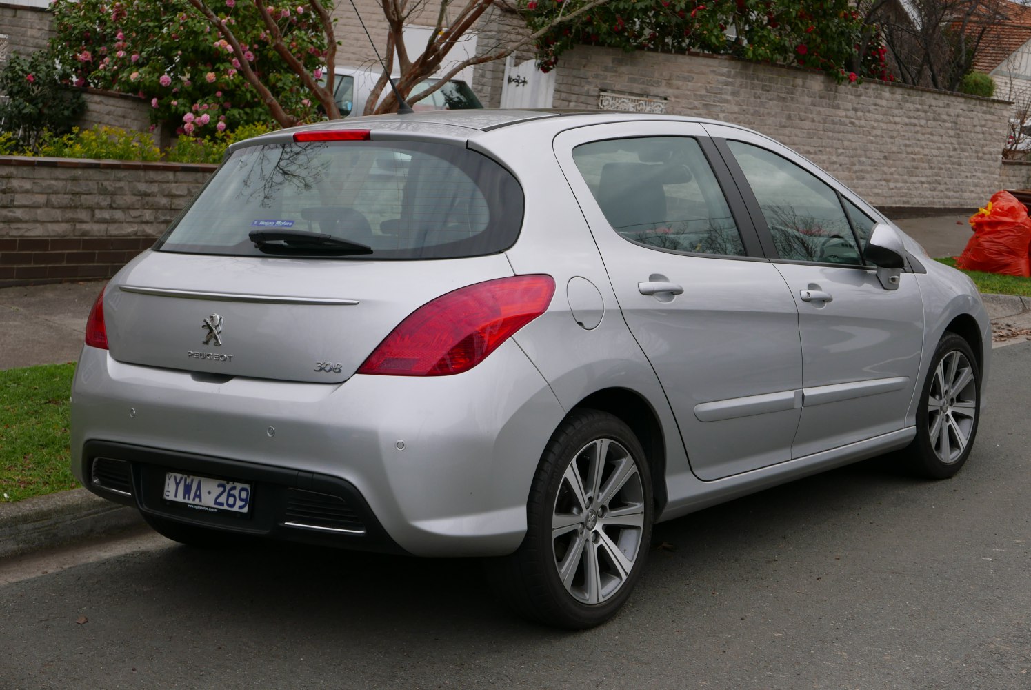 Rear-side view of silver hatchback with distinctive tail lights and alloy wheels