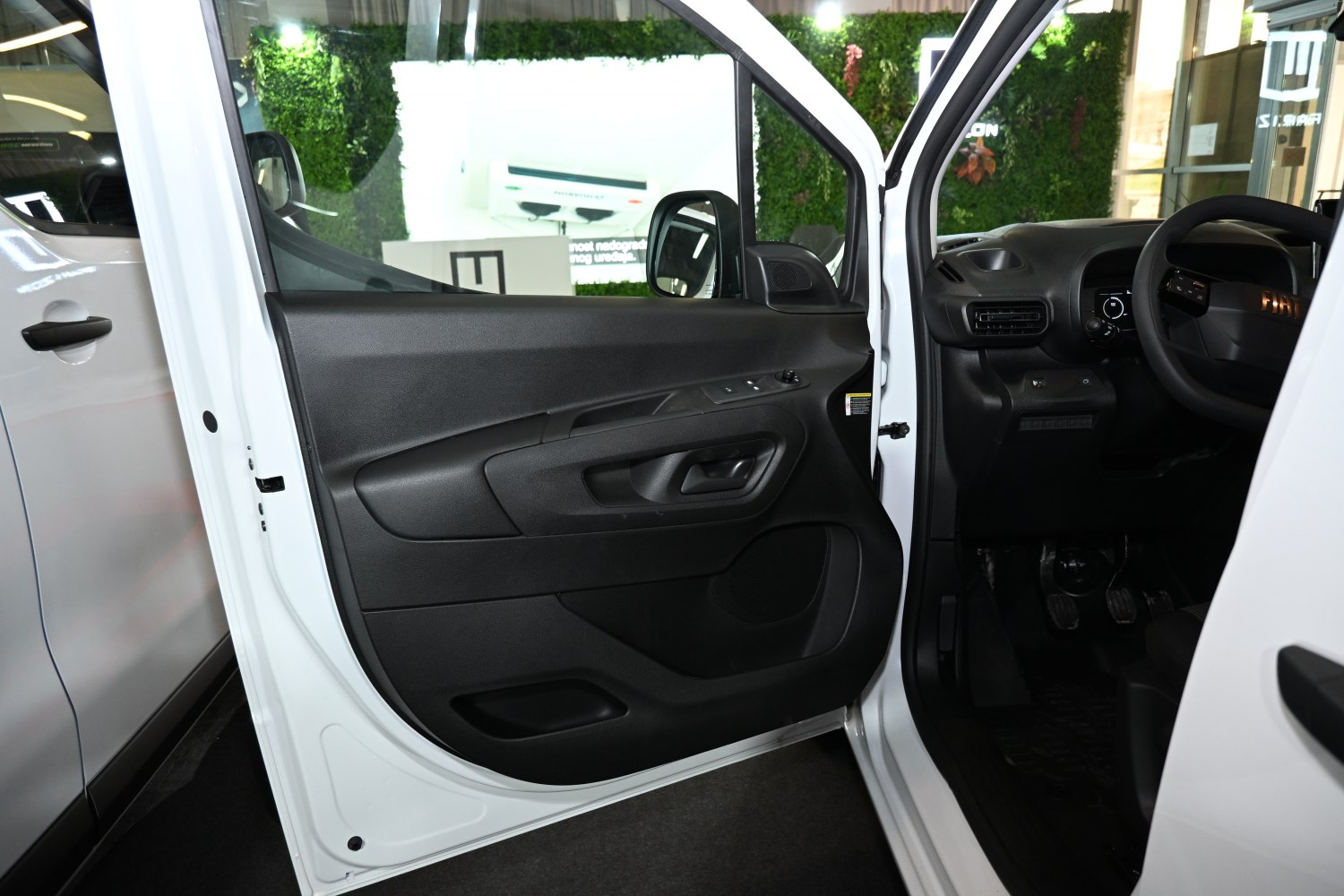 Interior door panel with driver side controls and ergonomic layout