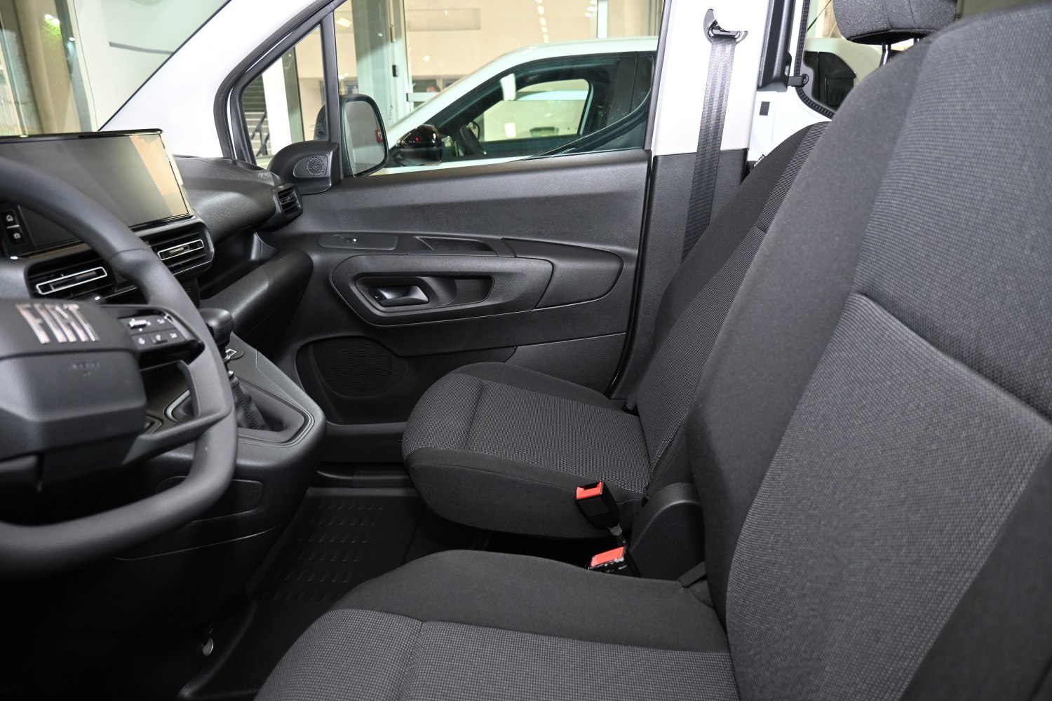 Front interior seats and dashboard with fabric upholstery and control panel