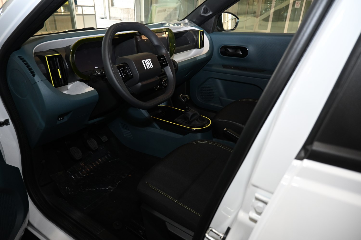 Modern dashboard with digital displays and distinctive steering wheel