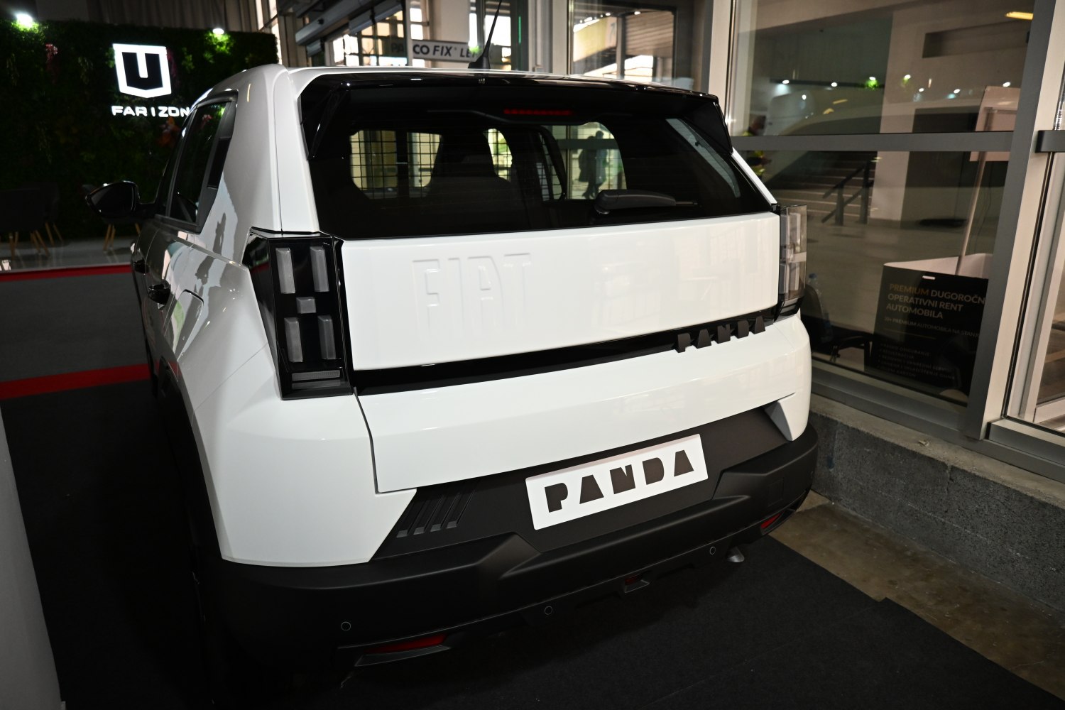 Rear view with black panel, embossed logo, and modern tail lights