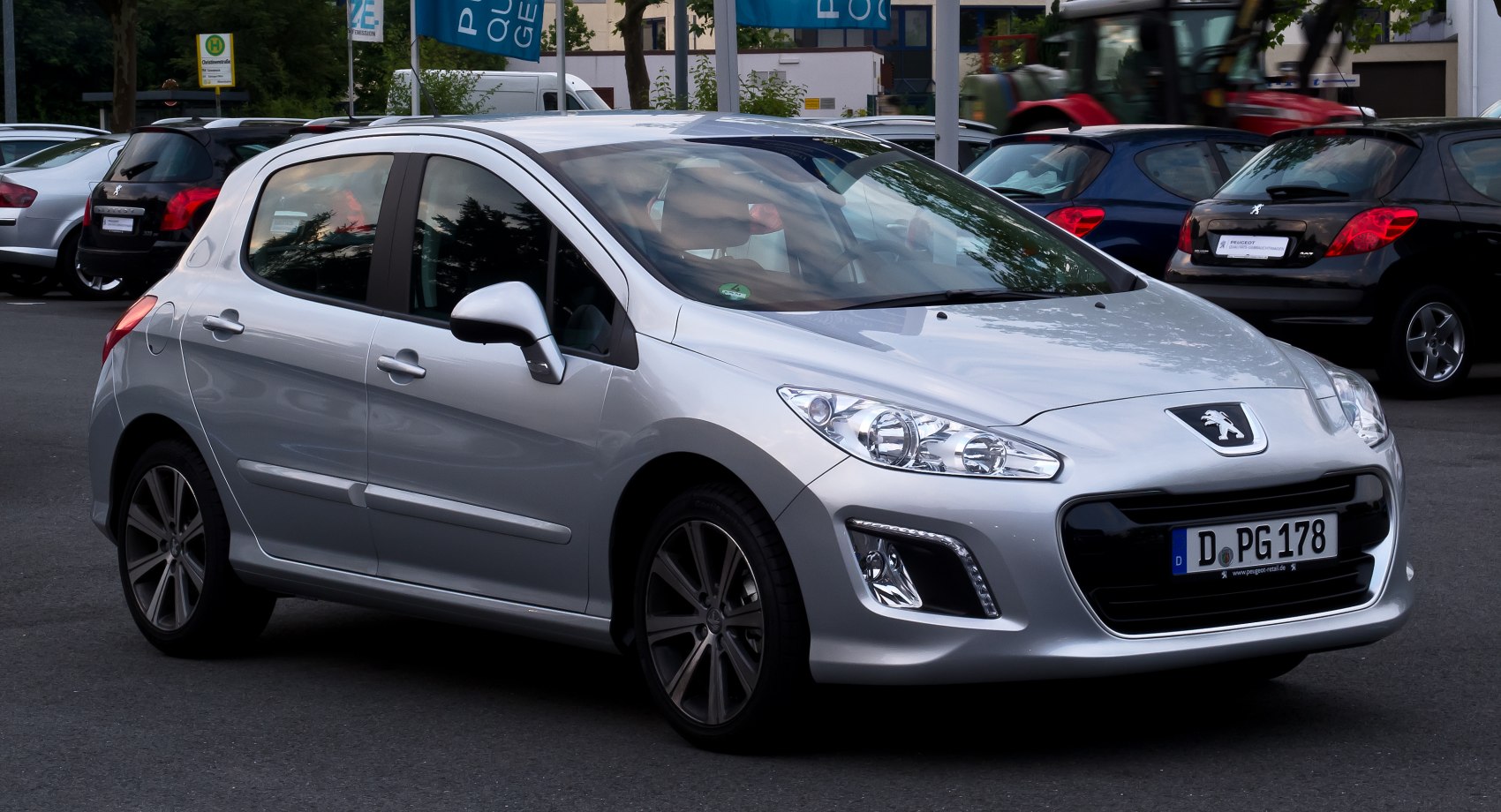 Front-side view of a compact hatchback with sharp headlights and alloy wheels