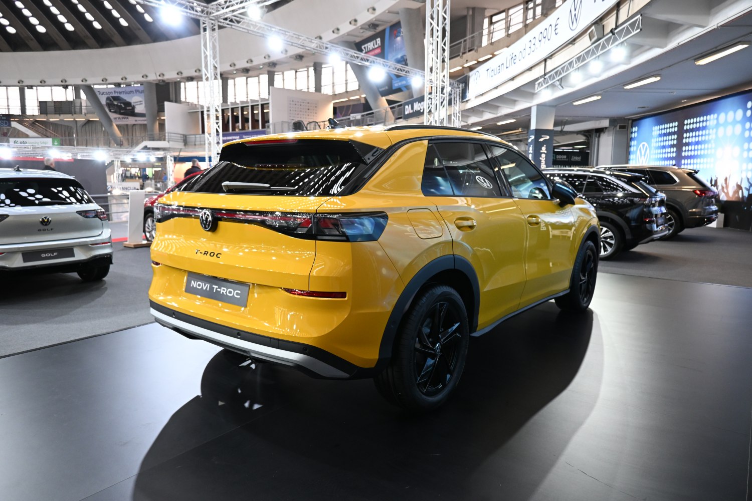Rear view of a yellow compact SUV with sleek LED tail lights and black alloy wheels