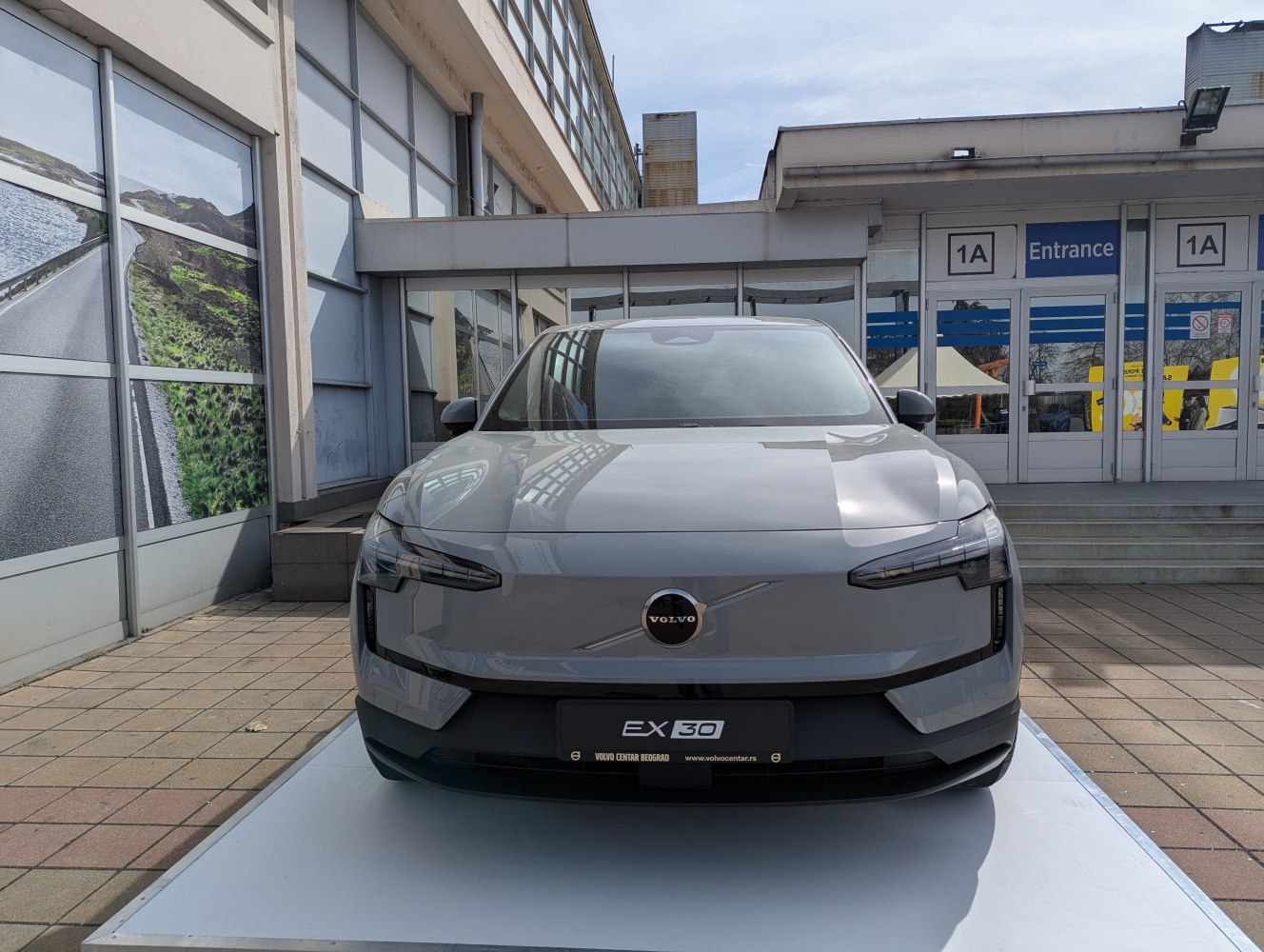 Front view of a compact electric vehicle with sleek LED headlights and minimalist grille
