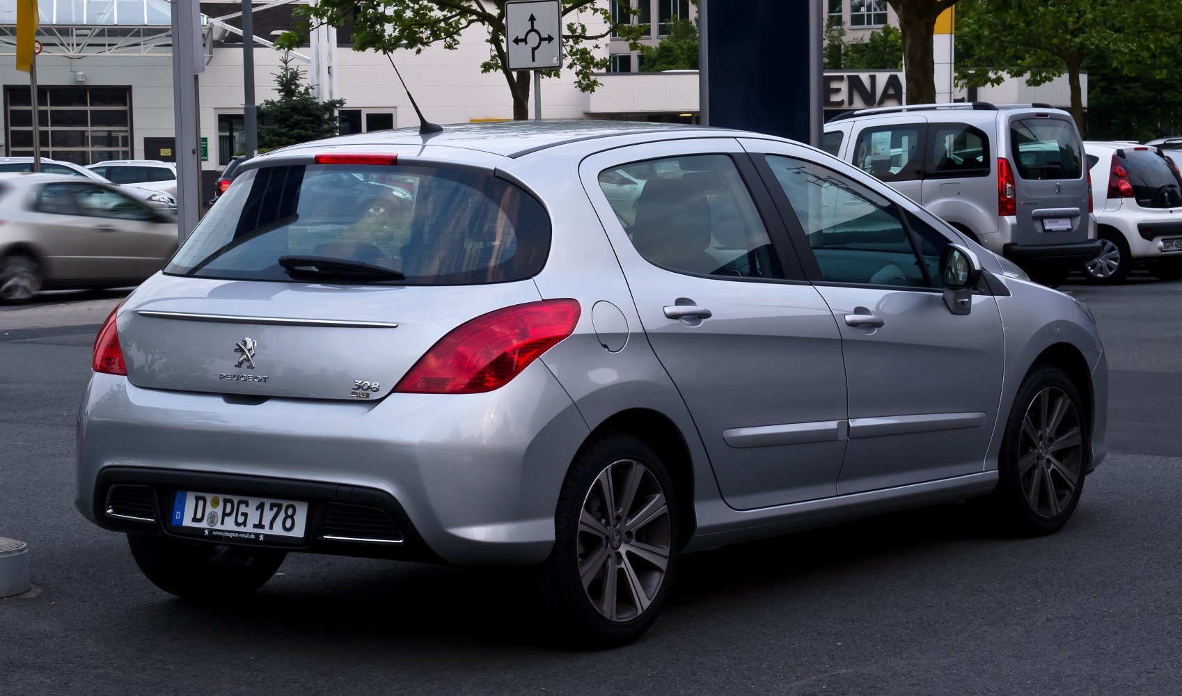 Rear and side view of silver compact hatchback featuring distinctive taillights and alloy wheels