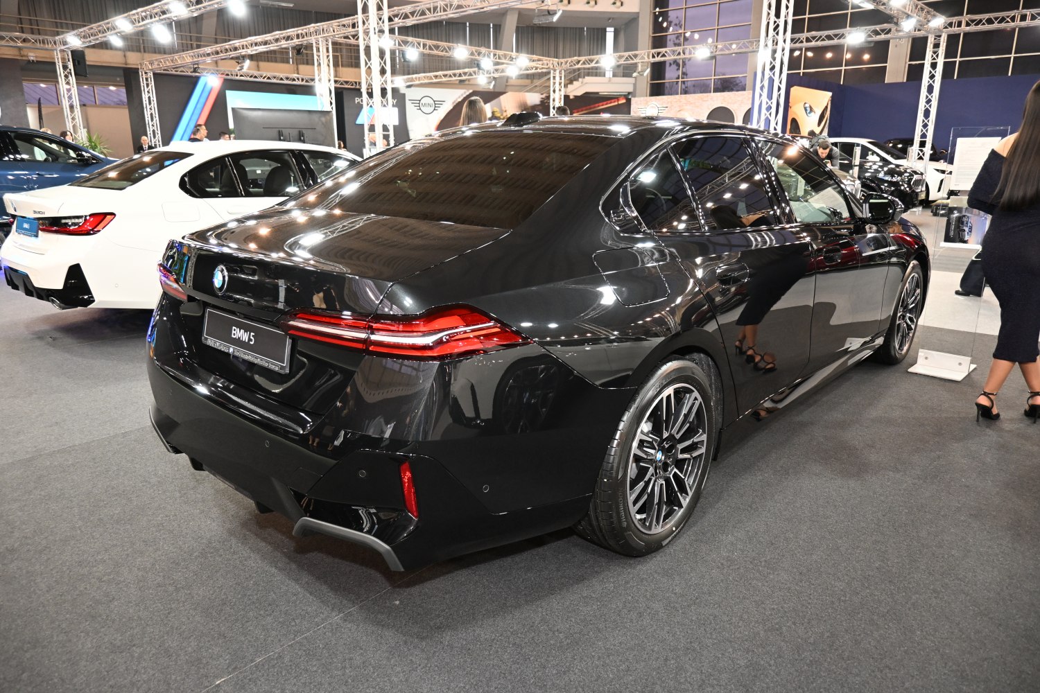Rear side view of modern sedan with sleek taillights and alloy wheels