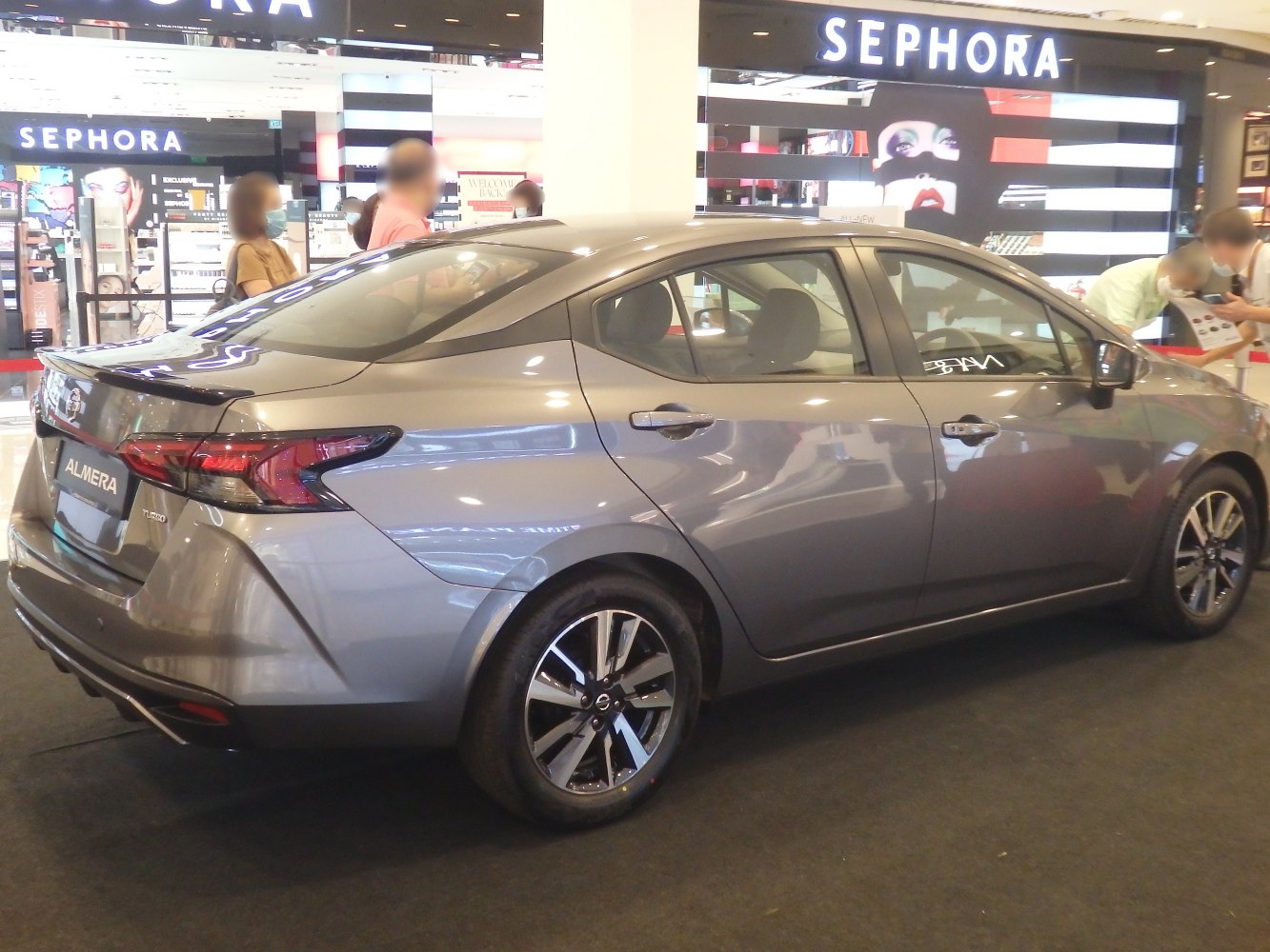 Rear-side view of sedan with LED tail lights and alloy wheels