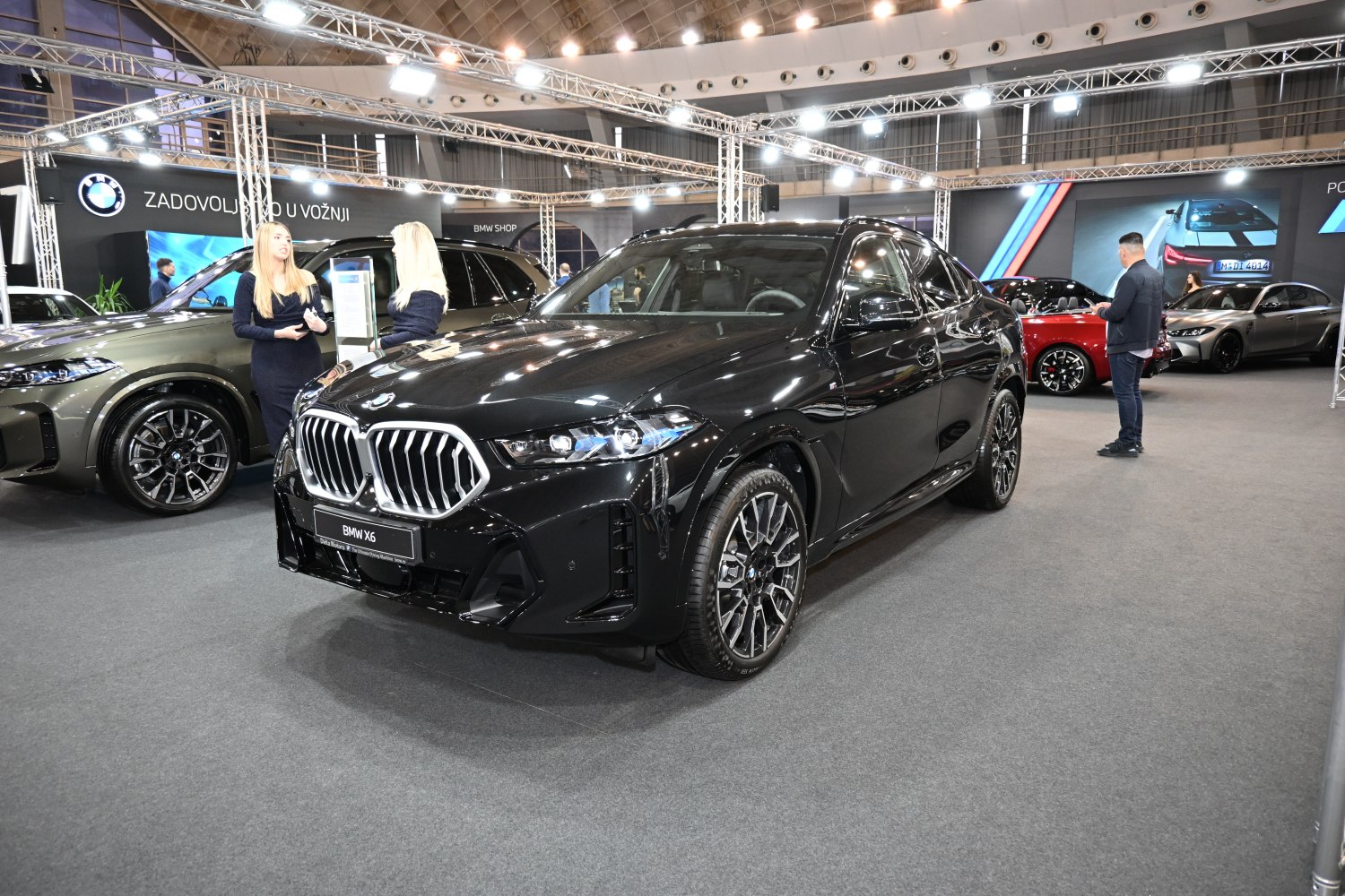 Front view of a facelifted BMW SUV with distinctive grille and headlights